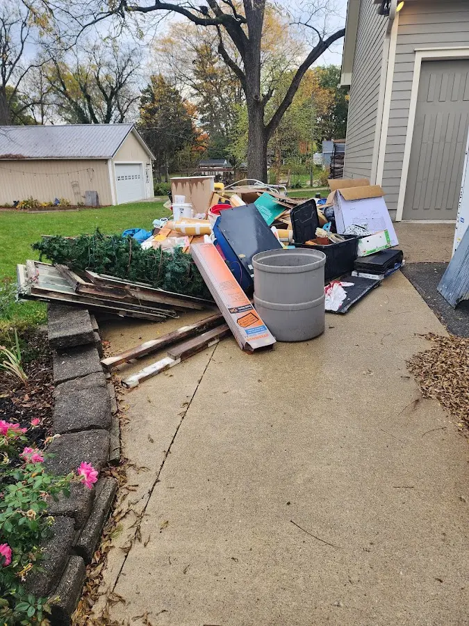 Dumpster being loaded with debris for Estate Cleanout Dumpster Rental in Dubuque